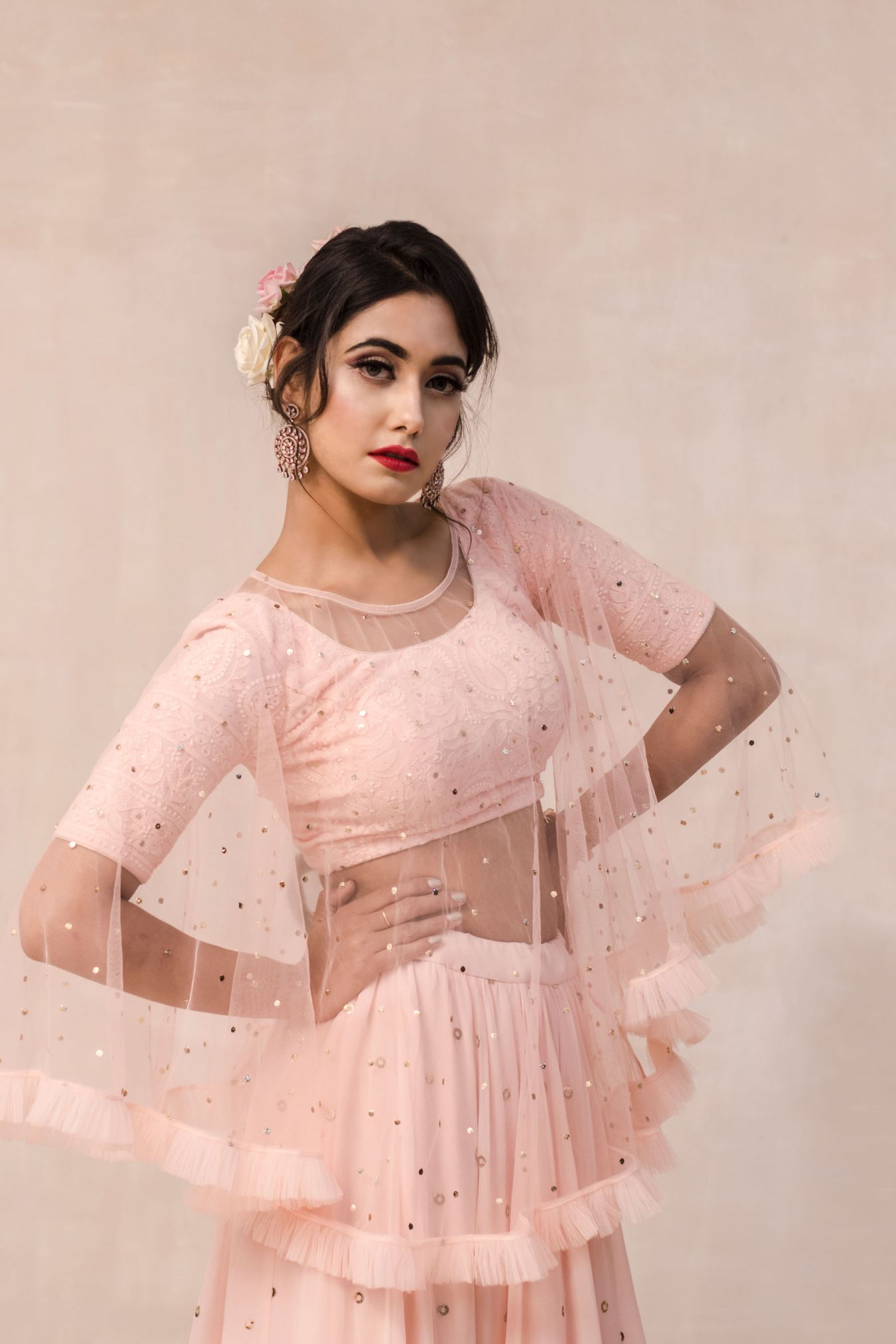 Vivacious Georgette Lehenga Paired with Handcrafted Chikan Blouse Embellished with Mukaish Rings All Over in Blooming Peach Color. Delicately Falling Sheer Cape with Frills for Accentuating the Style of the Whole Outfit